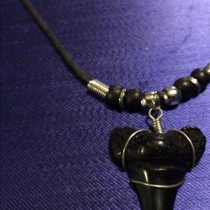 Black enamel coated sharks tooth.